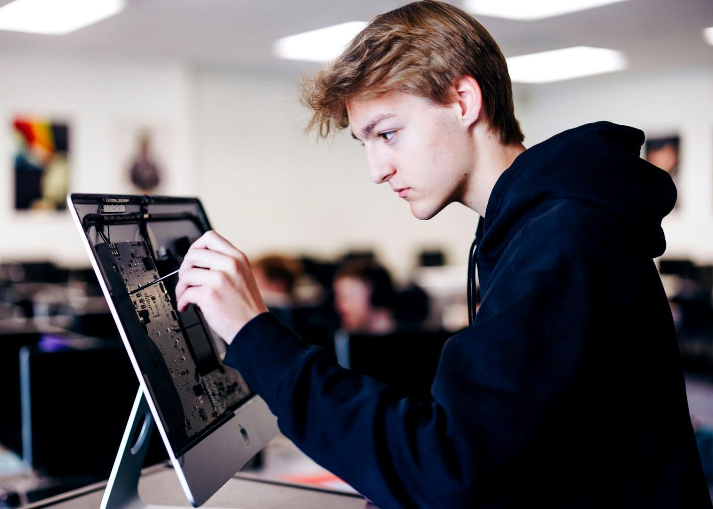 Student working on 3D character model in Blender workspace